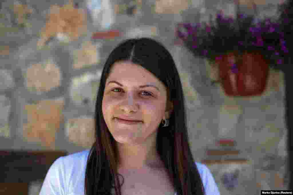 Emilija, a hotel receptionist, poses for a portrait in an old part of the waterside city of Ohrid. Emilija says she expects living standards to rise once the country joins the EU and NATO. "Greeks come here as tourists and we're friends," she says. "I can say only good things about them. It is only politics that is causing trouble between people."