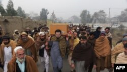 Relatives and residents carry the coffin of a victim from Bacha Khan university after a day an attack by militants in Charsadda on January 21.