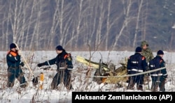 Personnel work at the scene of the crash in the village of Stepanovskoye, about 40 kilometers from Domodedovo airport, on February 12.