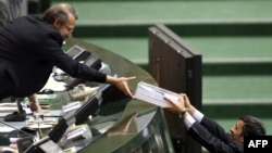 President Mahmud Ahmadinejad (right) handed over his draft annual budget to lawmakers on January 24.