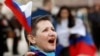 A pro-Russian demonstrator takes part in a rally in Simferopol on March 6 outside parliament as local legislators voted to join with Russia.