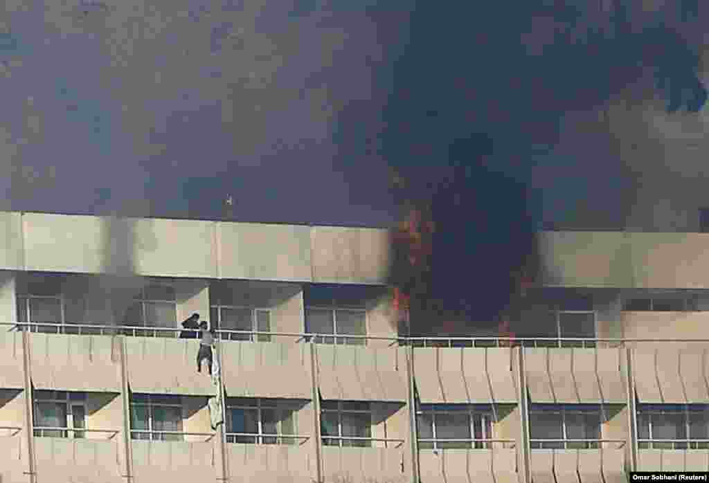 A man tries to escape from a balcony at Kabul&#39;s Intercontinental Hotel during an attack by gunmen in the Afghan capital on January 21. (Reuters/Omar Sobhani)