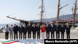 Balkan and EU leaders line up for a photo at the Western Balkans Summit in Trieste, Italy, on July 12. (Left to right: EU foreign policy chief Federica Mogherini, Serbian Prime Minister Ana Brnabic, Montenegrin Prime Minister Dusko Markovic, Austrian Chancellor Christian Kern, Kosovar Prime Minister Isa Mustafa, Albanian Prime Minister Edi Rama, French President Emmanuel Macron, Italian Prime Minister Paolo Gentiloni, German Chancellor Angela Merkel, Slovenian Prime Minister Miroslav Cerar, Chairman of the Council of Ministers of Bosnia and Herzegovina Denis Zvizdic, Croatian Prime Minister Andrej Plenkovic, Macedonian Prime Minister Zoran Zaev and British Foreign Secretary Boris Johnson.)