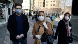 Residents in Tehran, Iran's capital, walk downtown wearing masks and gloves on February 27, 2020.