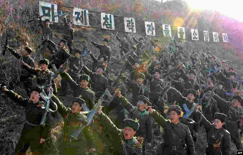 Members of the North Korean Worker-Peasant Red Guards shout anti-U.S. slogans at an undisclosed location. (AFP/KCNA)