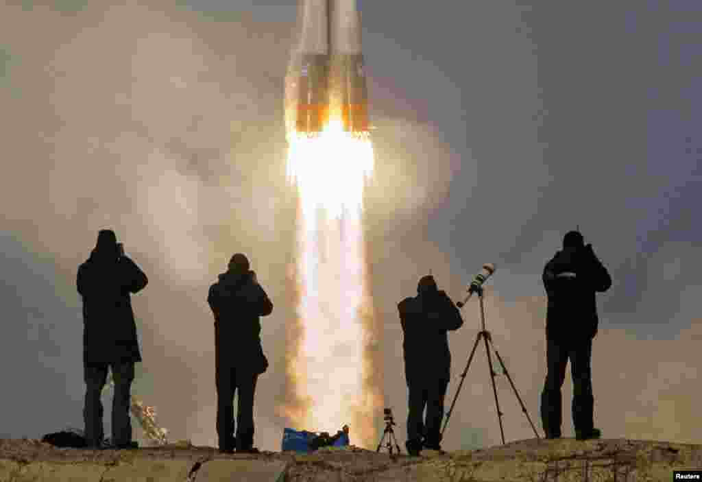 Photographers take pictures of the Soyuz TMA-19M spacecraft carrying the crew of Timothy Peake of Britain, Yuri Malenchenko of Russia and Timothy Kopra of the United States. The crew was en route to the International Space Station (ISS) from the launchpad at the Baikonur Cosmodrome in Kazakhstan, on December 15, 2015. (Reuters/Shamil Zhumatov)