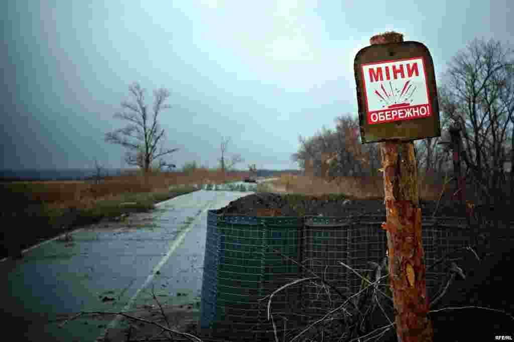 A sign warns about mines on the land ahead. This is the furthest point of the 29th checkpoint along the front line.