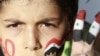 Мальчик с нарисованным сирийским флагом на пальцах протестует против президента Сирии Башара Асада. Амман, Иордания, 12 июня 2011 года.