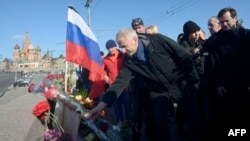 Vygaudas Usackas, head of an EU delegation to Russia, lays flowers on February 28 with other ambassadors of EU member states at the spot where Russian opposition leader Boris Nemtsov was shot dead in Moscow.
