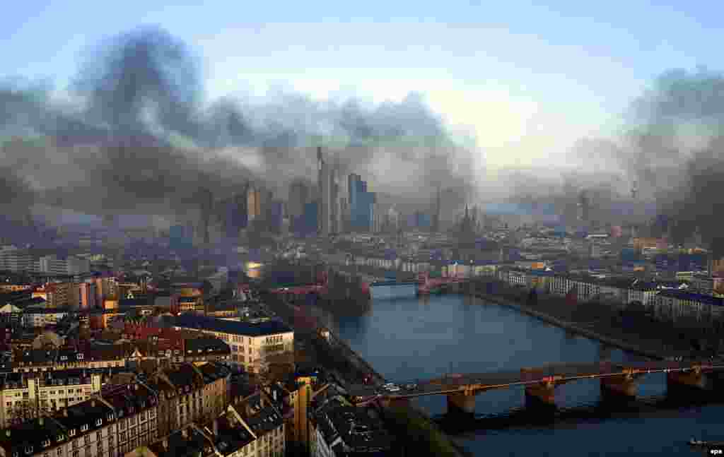 Smoke engulfs the skyline of Frankfurt, Germany, as a result of an anticapitalist protest near the European Central Bank (ECB) building before the official opening of its new headquarters. (epa)