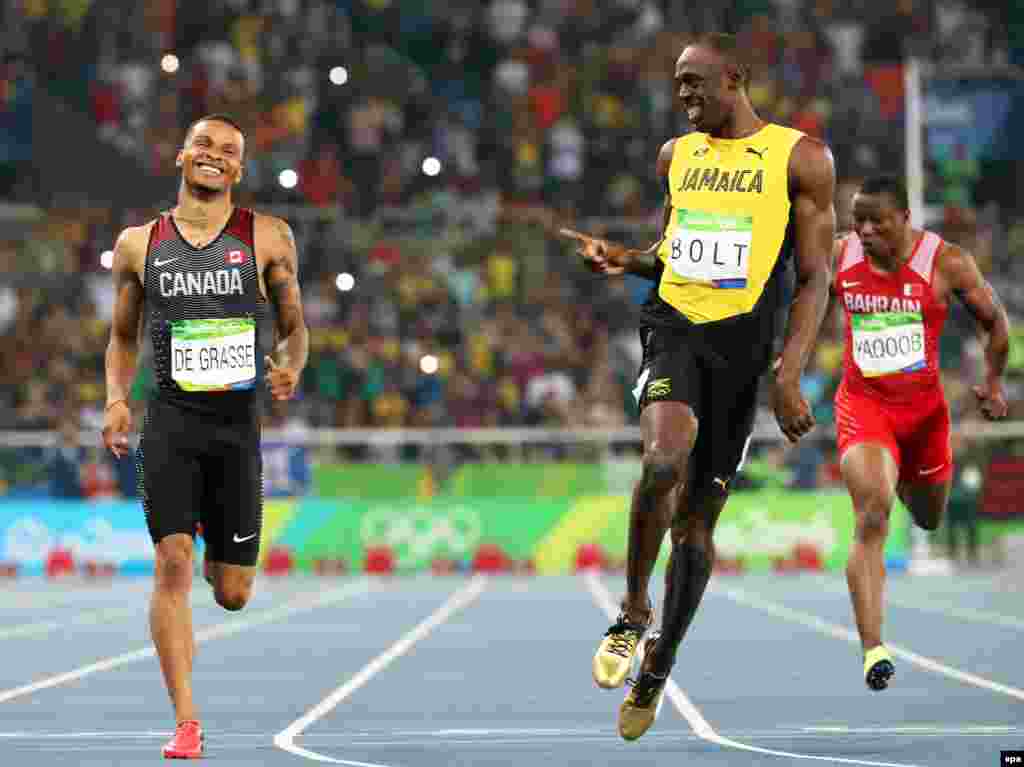 Andre de Grasse (left) of Canada and Usain Bolt of Jamaica react after competing during the men&#39;s 200-meter semifinals.