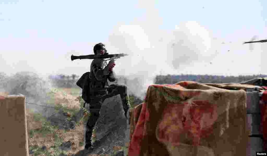 An Iraqi soldier launches a rocket-propelled grenade toward Islamic State militants, west of Fallujah. (Reuters)