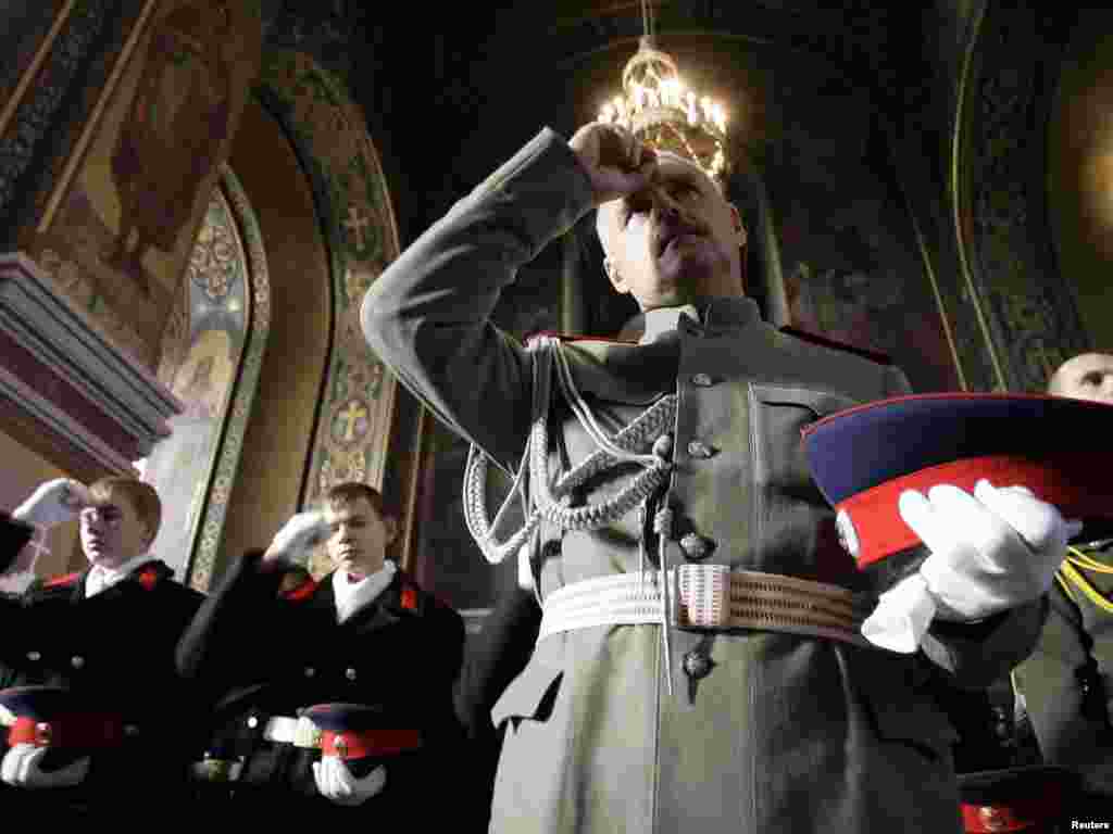 Russian Cossacks and cadets bless themselves during a religious service dedicated to the feast of the Protecting Veil of the Mother of God at a cathedral in the town of Novocherkassk, some 40 kuilometers northeast of Rostov-na-Donu, on October 14. Russian Cossacks honor this Orthodox feast from the earliest times. Photo by Vladimir Konstantinov for Reuters