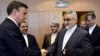 Member of the European Parliament David McAllister (L) welcomes Chairman of the Committee for Foreign Policy and National Security of Iran's parliament, Alaeddin Boroujerdi at the European Parliament, in Brussels, January 23, 2018