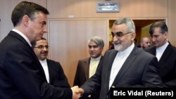 Member of the European Parliament David McAllister (L) welcomes Chairman of the Committee for Foreign Policy and National Security of Iran's parliament, Alaeddin Boroujerdi at the European Parliament, in Brussels, January 23, 2018