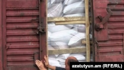 Armenia -- A worker opens a rail car laden with imported grain seeds, 1Oct 2010.