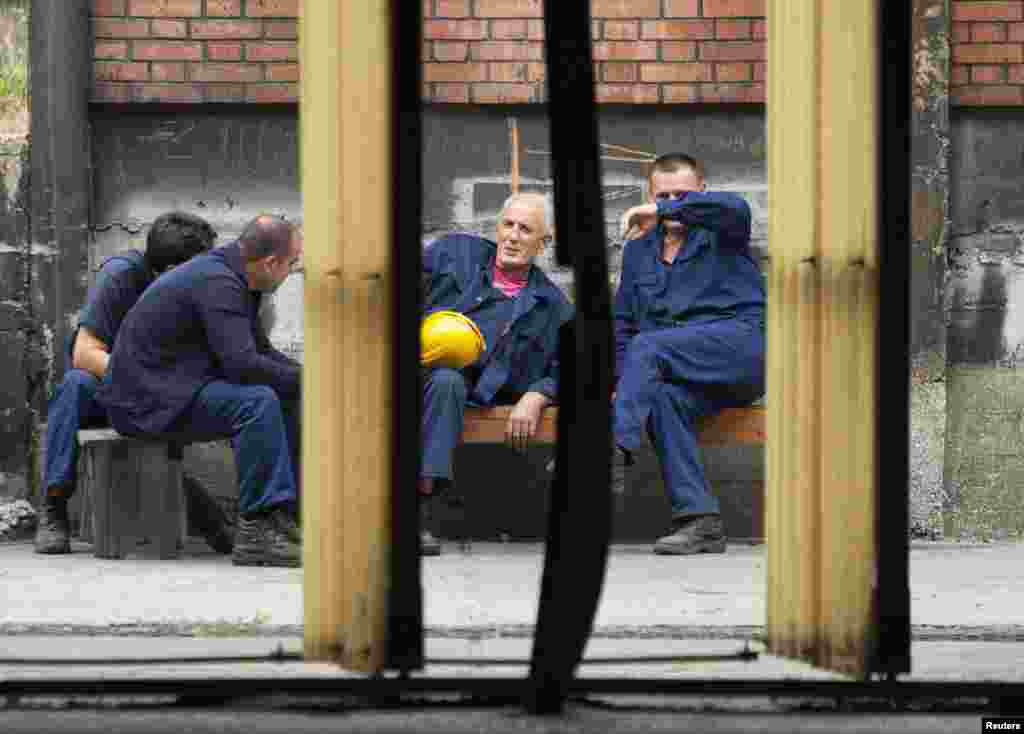 Workers take a break outside the foundry.