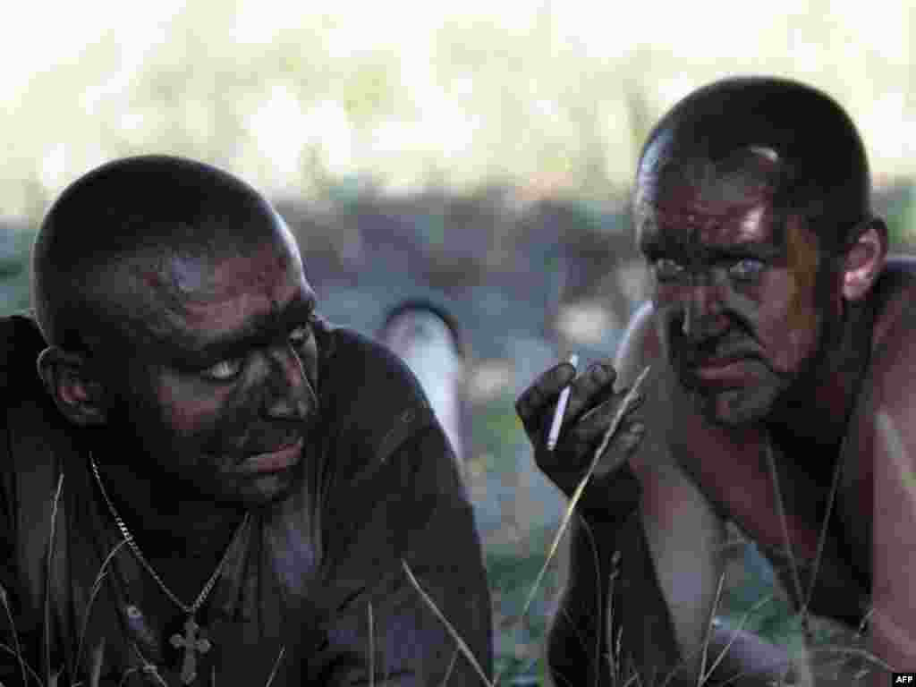 Rescue workers smoke during a break in the effort to find missing miners after an explosion at Ukraine's Sukhodolskaya-Vostochnaya coal mine, in the Lugansk region, on July 29. Photo by Aleksandr Khudoteply for AFP