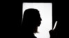 GENERIC – Silhouette of a woman using smart phone mobile