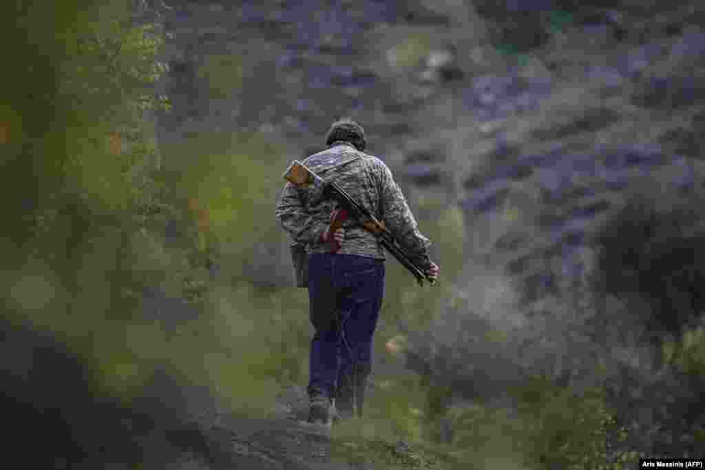 A volunteer fighter strolls near a village south of Stepanakert. &nbsp; In early October, a volunteer fighter told AFP: &quot;We are a small nation and we don&#39;t have any other alternative but to win. This is why everyone needs to fight.&quot;