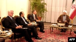 Iran's top nuclear official Hassan Rowhani (R) meets with France Francois Nicoullaud (3rd L) Britain Richard Dalton (2nd L) and German Paul Von Maltzhn in Tehran 14 November 2004. Iran has agreed to suspend "nearly all" of its uranium enrichment-related a