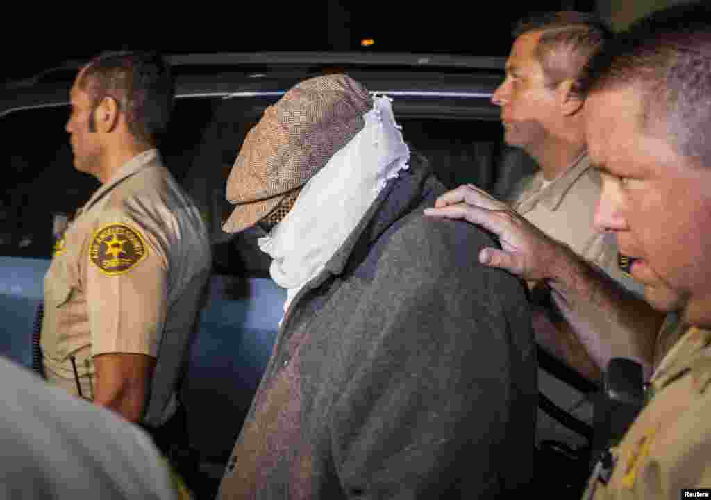 Nakoula Basseley Nakoula (center) is escorted out of his home by Los Angeles County police in Cerritos, California, on September 15. Nakoula is thought to be behind a controversial anti-Islamic film, &quot;The Innocence of Muslims,&quot; that sparked violent protests in Muslim countries, but it was suspected bank fraud that led to his arrest. (Reuters/Bret Hartman)