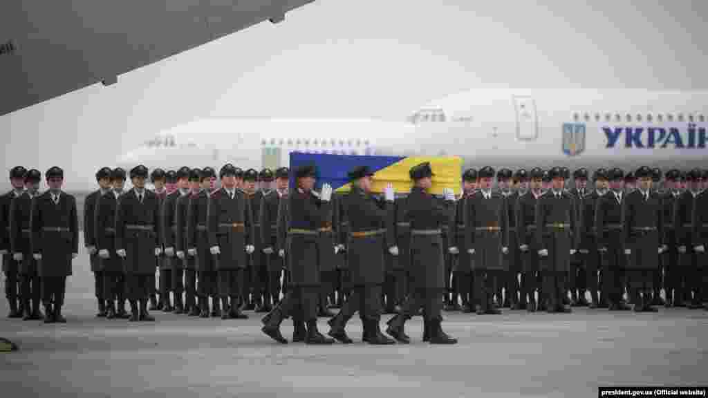 Soldiers carry a coffin containing the remains of one of the 11 Ukrainian victims of the Ukraine International Airlines Flight PS752 plane disaster.