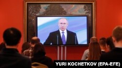 Russian President Vladimir Putin is shown on a TV screen during his inauguration ceremony on May 7.