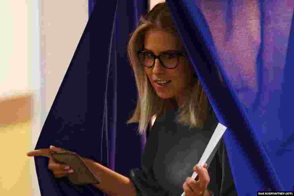 Russian opposition activist Lyubov Sobol leaves a polling booth prior to casting her vote in Moscow. 