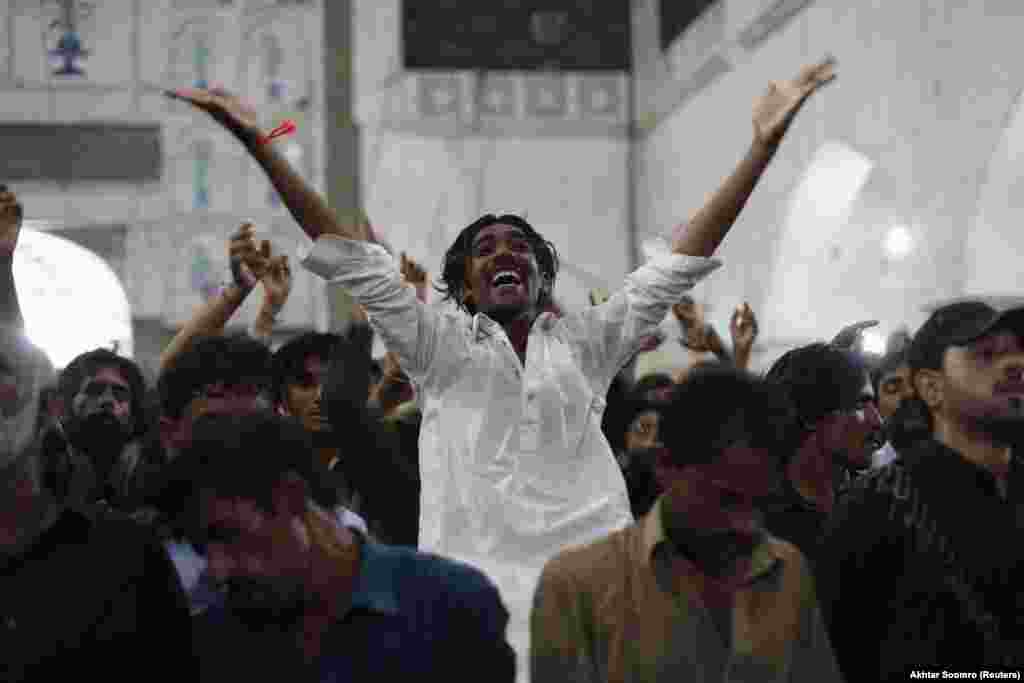 A devotee dancing to the beat of the drum at the Lal Shahbaz Qalandar shrine in 2013. The Huffington Post describes Sufism as a branch of Islam which "employs music, dance and spiritual recitation to awaken the God who Sufis say is asleep in the human heart."