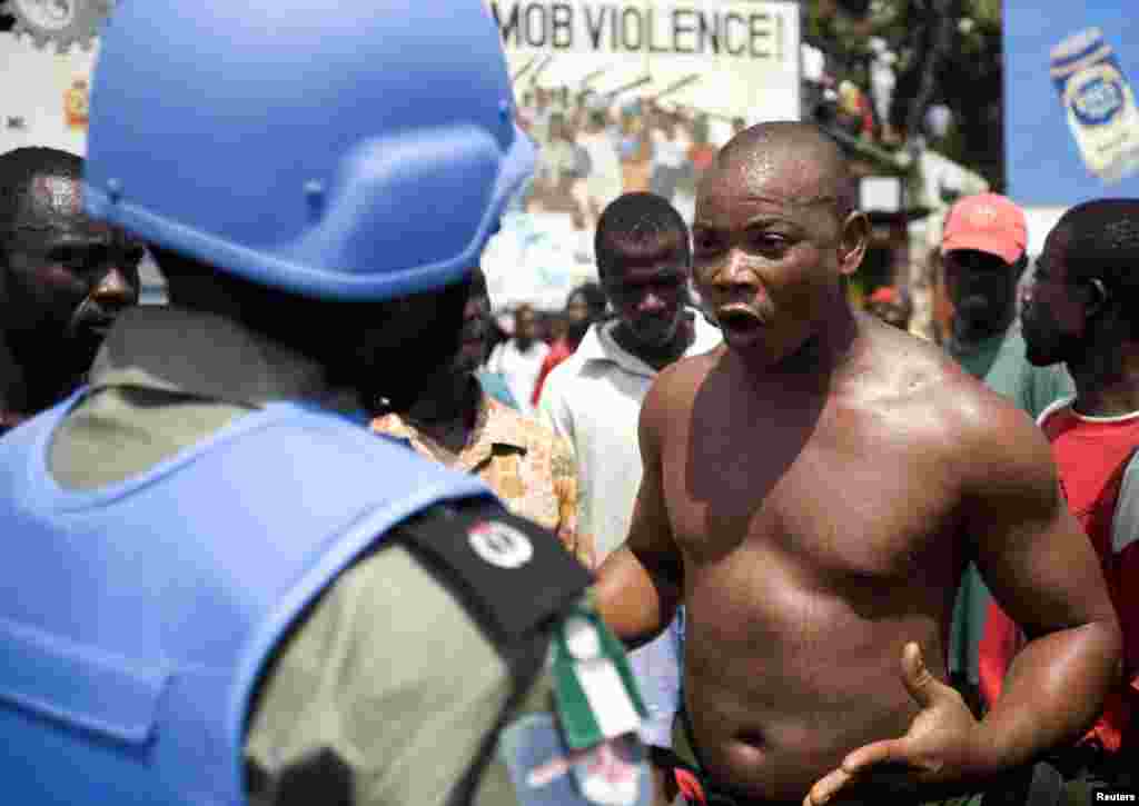 A former Liberian soldier shouts in front of a Nigerian UN peacekeeper during an antigovernment demonstration concerning wage arrears in Monrovia in February 2007.