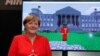 GERMANY -- German Chancellor Angela Merkel stands next to a screen depicting a Minecraft rendition of her and the Reichstag building during the opening of the world's largest computer games fair Gamescom in Cologne, Germany, August 22, 2017. 