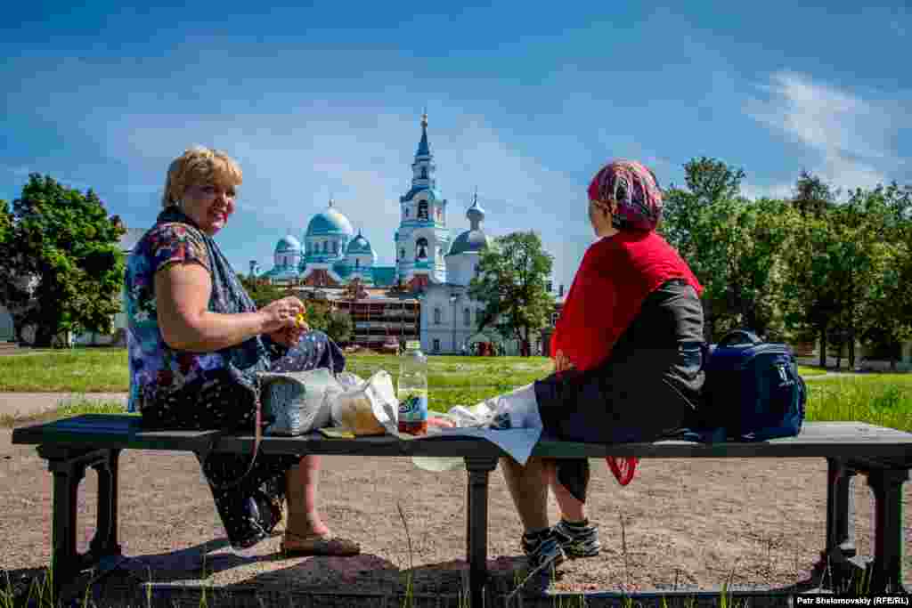 Visitors eat smoked trout prepared by the local monks.