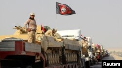 A convoy of Iraqi security forces advances on the outskirts of Mosul on October 12.