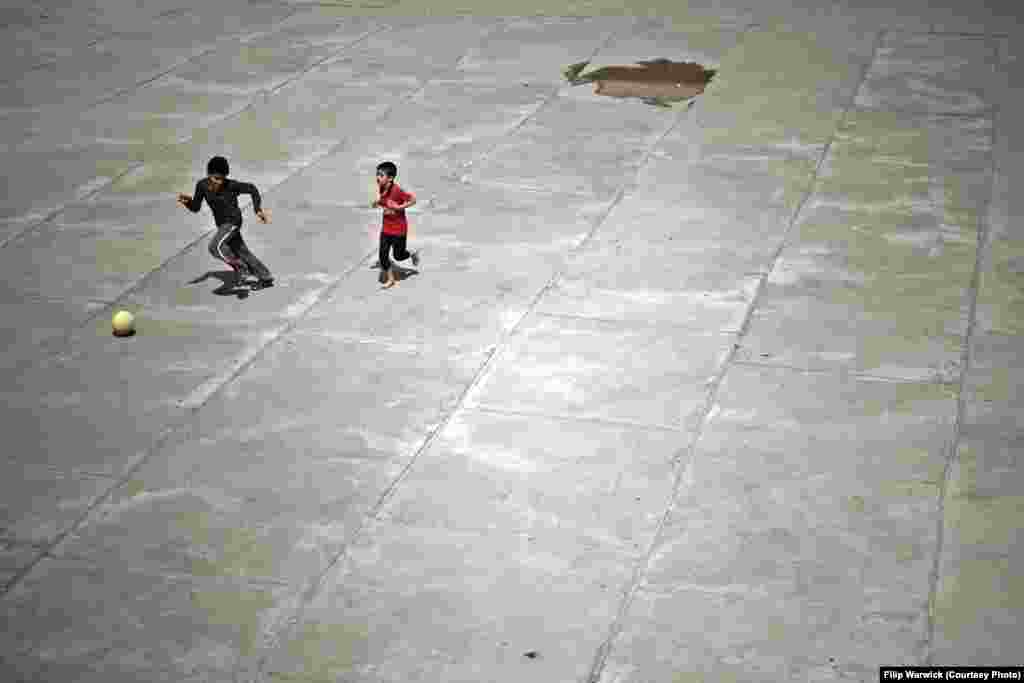 Two refugee boys play soccer in the camp&rsquo;s courtyard.&nbsp;