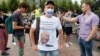 An opposition supporter, wearing a protective face mask and a T-shirt with a modified image of Russian President Vladimir Putin, attends a protest against the constitutional amendments in central Moscow on July 1.