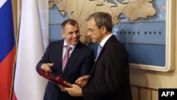 Crimean parliament speaker Vladimir Konstantinov (L) speaks with French right wing UMP party member of parliament Thierry Mariani at the State Council in Simferopol, Crimea, July 23, 2015