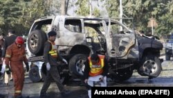 FILE: Pakistani security officials inspect the scene of a bomb attack that targeted a senior police officer in Khyber Pakhtunkhwa Province.