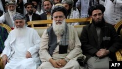 Afghanistan -- Former Islamist warlord, Abdul Rasul Sayyaf (C) sits with his two vice-presidential candidates, Mohammad Ismail Khan (L) and Abdul Wahab Erfan during a registration process for the forthcoming presidential elections at the Independent Elect