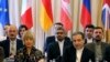 The European Union's political director Helga Schmid and Iranian deputy Foreign Minister Abbas Araghchi, from left, wait for a bilateral meeting as part of the closed-door nuclear talks with Iran at a hotel in Vienna, July 28, 2019