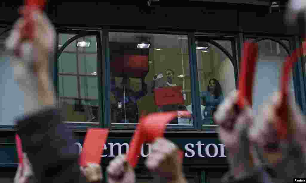 Shop assistants joined the protest from windows overlooking the street.