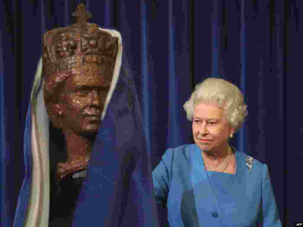 Queen Elizabeth II unveils a portrait bust by sculptor Oscar Nemon at the House of Lords in London in October 2009.