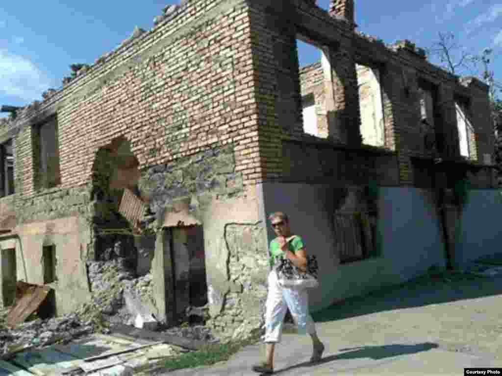A woman walks past a destroyed building in the South Ossetian capital of Tskhinvali. - "I arrived in South Ossetia and sat down in the first cafe I saw. And three Ossetians invited me over for some food and drink and they asked who I was. And I replied that I was a Czech journalist. And they said: 'Look, we don't want to tell you how to do your job. We don't want to influence you. But we want to tell you one thing. In this place, you won't run into anyone who'll say a bad word against the Russians and who would say a good word about the Georgians. I didn't believe it. But then I spent three days in Tskhinvali. And it was true."