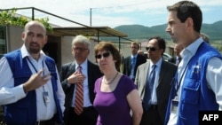 EU foreign-policy chief Catherine Ashton (center) speaks with EU monitors of the Georgia-South Ossetia border zone in July 2010, where Russia reneged on agreements it had made.