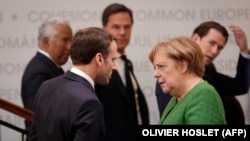 French President Emmanuel Macron (left) and German Chancellor Angela Merkel in Sibiu, Romania, on May 9