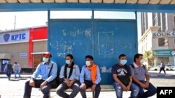 Люди в защитных масках ждут на автовокзале в Кувейте на фоне глобальной вспышки нового коронавируса. 2 марта 2020 года. 
