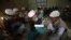 A student recites as others listen while they memorize the Koran at the Jamia Binoria Al-Alamia Seminary Islamic Study School in Karachi.