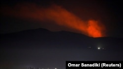 Smoke rises during Israeli airstrikes past a mountain as seen from Damascus countryside, Syria December 25, 2018