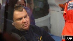 Ukrainian opposition activist Dmitry Bulatov sits in an ambulance at the airport in Vilnius, where he arrived for treatment on February 2.