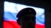 RUSSIA -- A serviceman stands in front of a screen displaying a Russian flag during a news briefing, organized by Russian defence and foreign ministries and dedicated to SSC-8/9M729 cruise missile system, at Patriot Expocentre near Moscow, Russia January 